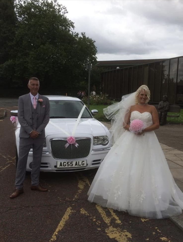 New wedding photo beside the white Baby Bentley
