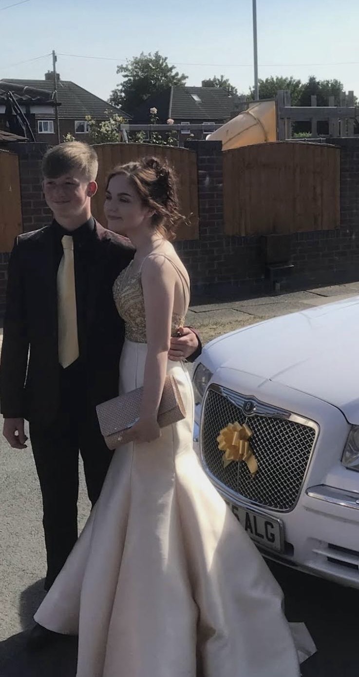 Prom guests beside the Worsley Wedding Cars vehicle