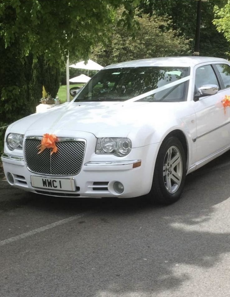 Prom guests beside the Worsley Wedding Cars vehicle