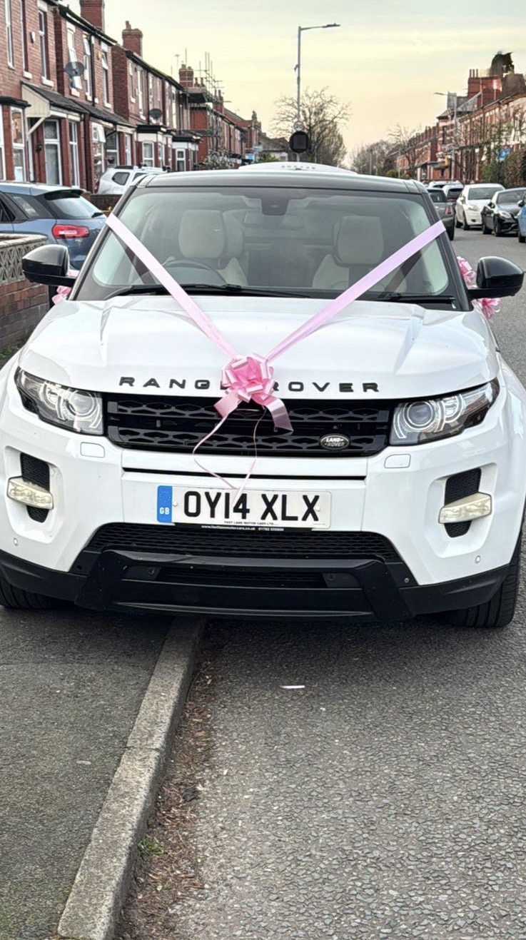 White Range Rover Evoque with pink wedding ribbons